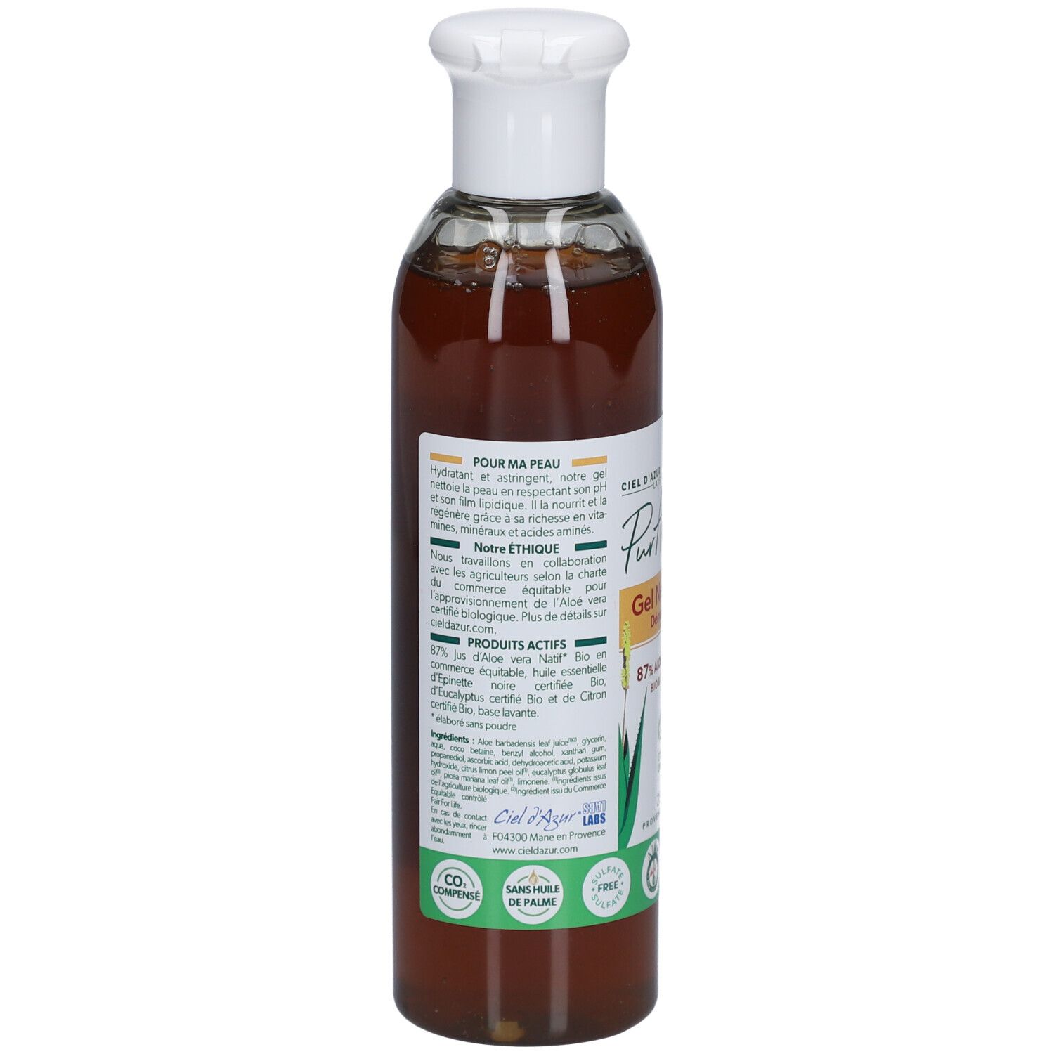Achterkant van de fles. Etiket met productinformatie, ingrediënten en bio-labels. Transparante vloeistof zichtbaar.