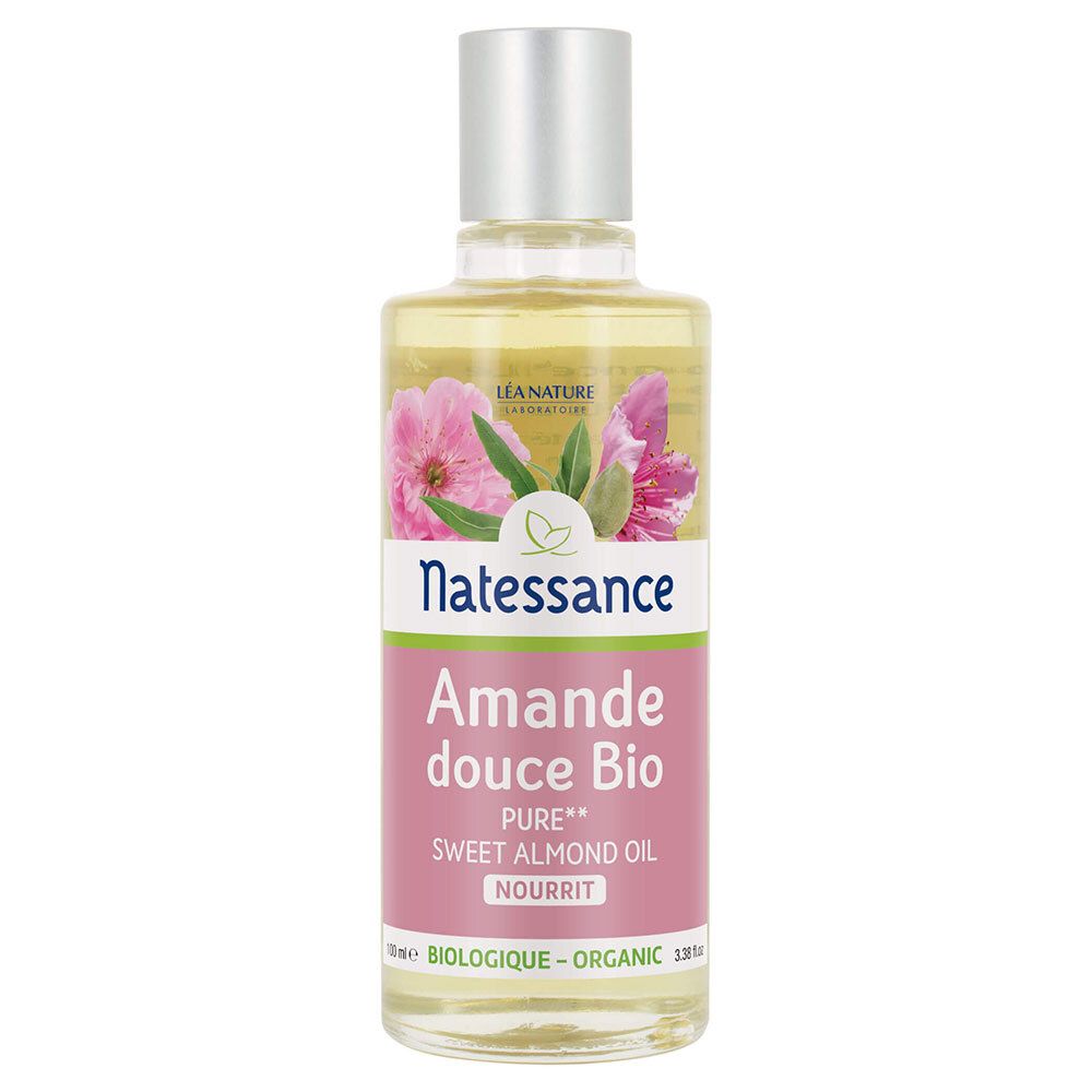 Transparante glazen fles met zilveren dop. Label: Natessance, Amande douce Bio, Sweet Almond Oil. Met bloemenafbeelding.