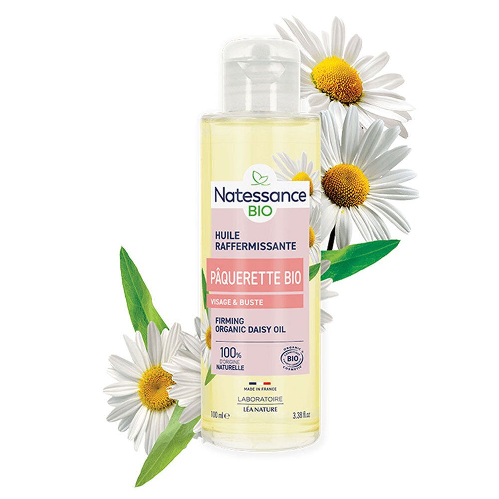 Natessance Bio oliefles met madeliefjes. Witte bloemen omringen de fles. Roze etiket met tekst.