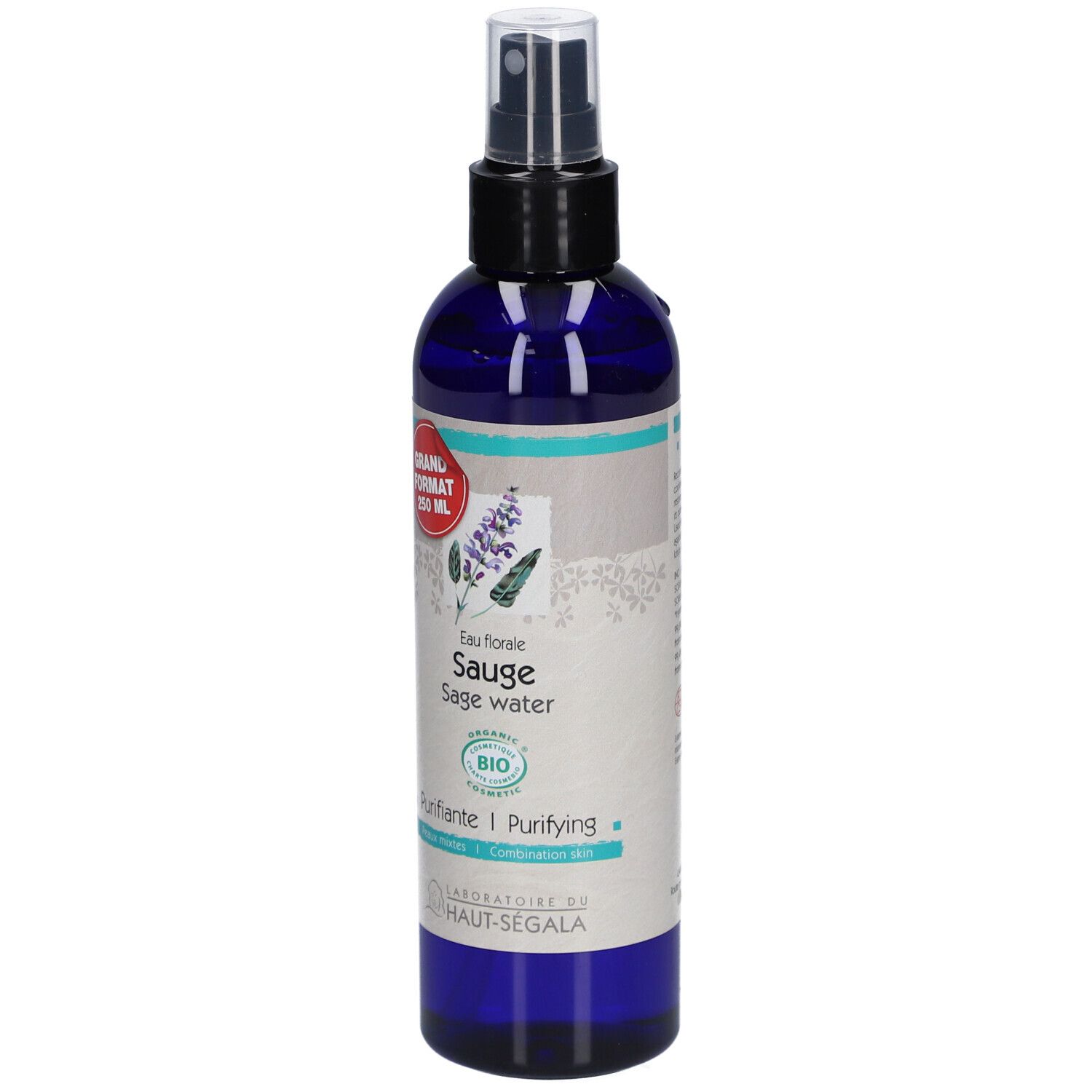 Flacon bleu transparent avec vaporisateur noir. Étiquette avec nom du produit, label bio et autocollant rouge.