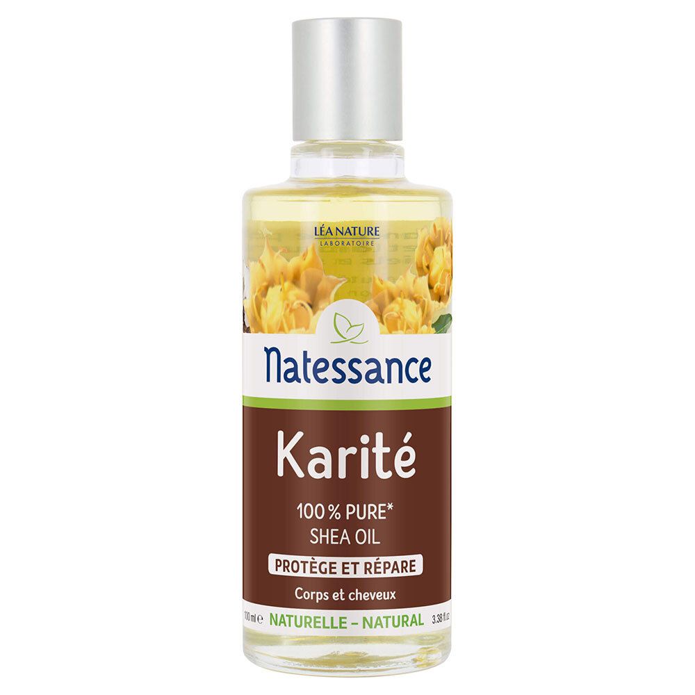 Transparante glazen fles met zilveren dop. Etiket met "Natessance Karité" en "100% Pure Shea Oil".