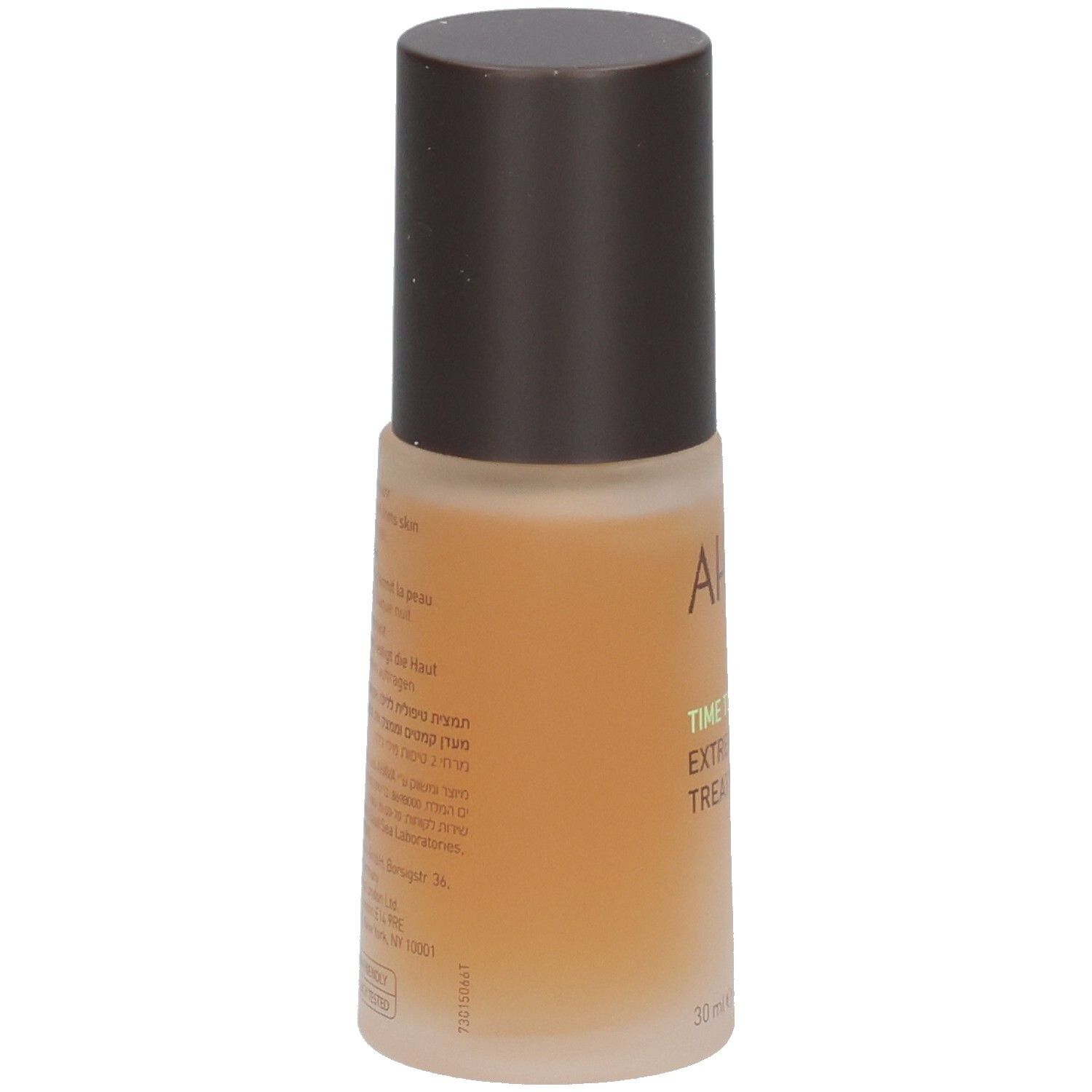 Bruine fles met bruine dop. Opschrift AHAVA, TIME TO REVITALIZE, EXTREME NIGHT TREATMENT. Tekst op achterkant.