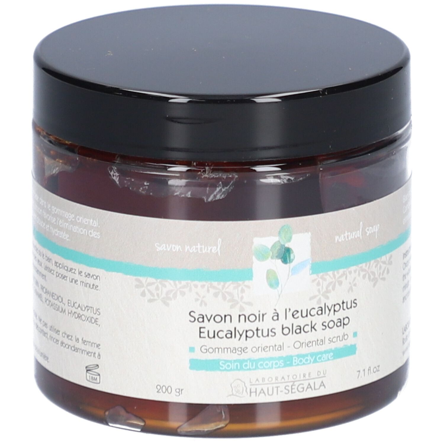 Bruine glazen pot met zwarte deksel. Opschrift: Savon noir à l'eucalyptus, Eucalyptus black soap, Gommage oriental, Soin du corps.