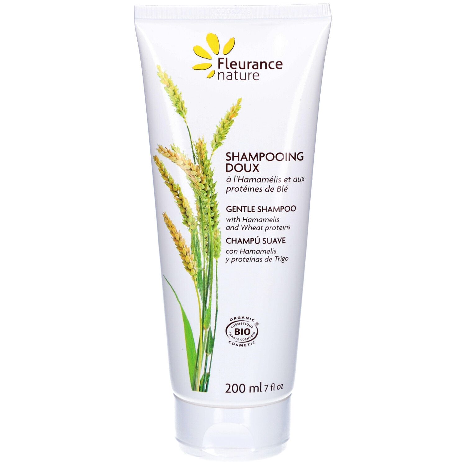 Witte shampoo tube met geel bloemenlogo. Tekst: "Shampooing Doux" en "Gentle Shampoo". Bio-certificering.