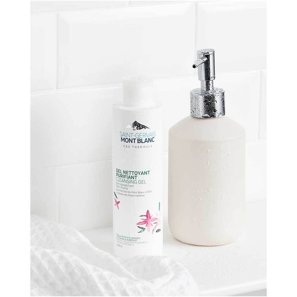 Gel nettoyant et distributeur de savon blancs. Flacon avec inscription Saint-Gervais Mont Blanc. Sur fond blanc.