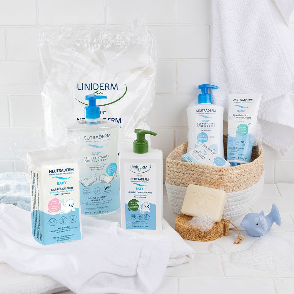 Verschillende Neutraderm Baby producten. Reinigingswater, waslotion, doekjes. Op witte achtergrond. Mand met accessoires.