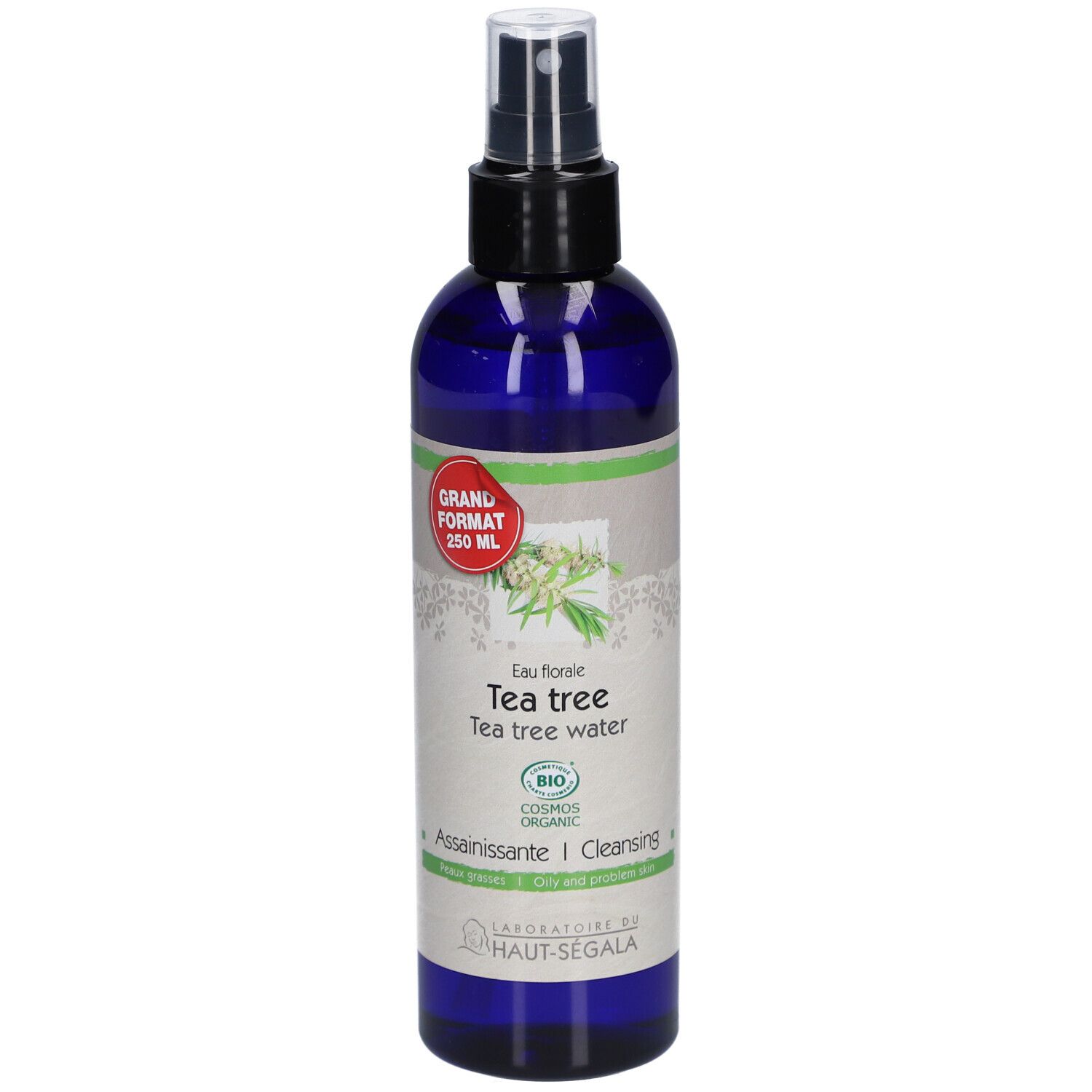 Flacon bleu avec vaporisateur. Étiquette : Eau florale de tea tree. Certification bio. Grand format.