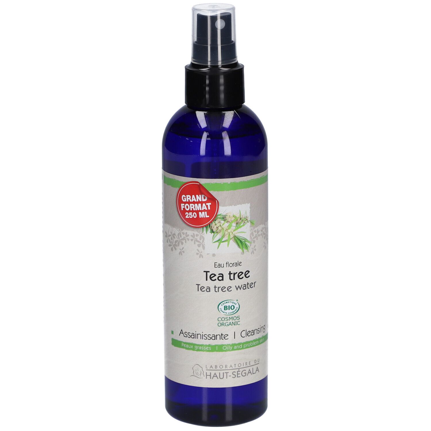 Flacon bleu avec vaporisateur. Étiquette : Eau florale de tea tree. Certification bio. Grand format.