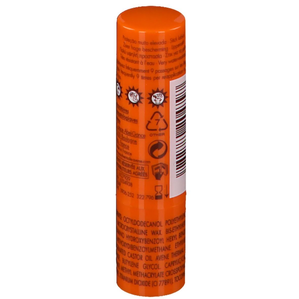 Achterkant van een oranje lippenbalsem. Tekst en symbolen. Detailweergave.