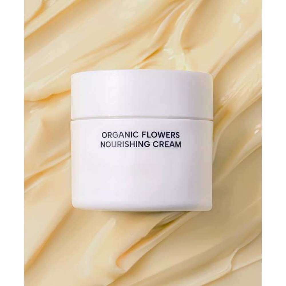 Pot blanc sur fond crème. Inscription: ORGANIC FLOWERS NOURISHING CREAM.