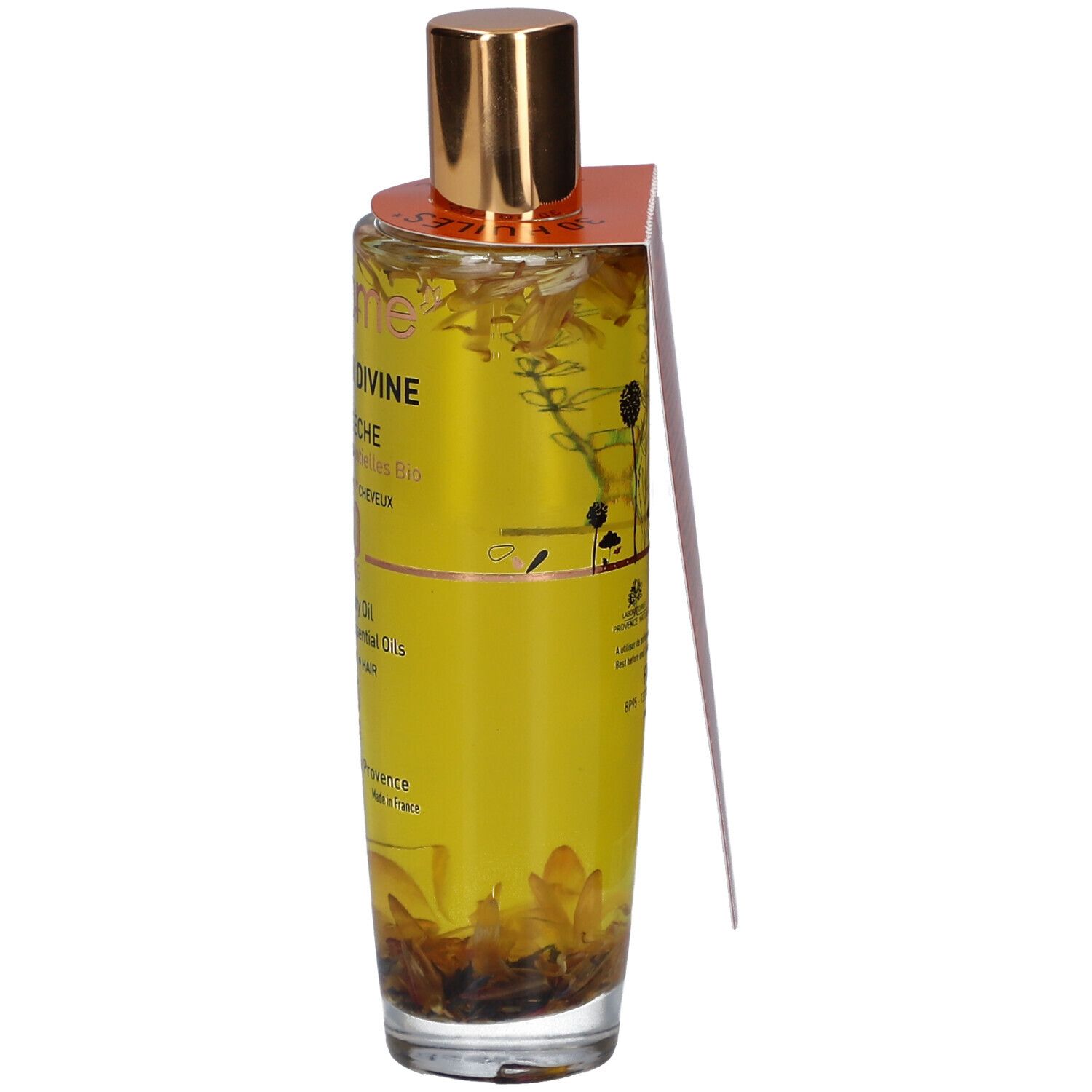 Glazen fles met gouden dop en etiket. Bevat een gele vloeistof met bloemen. Opschrift: Infusion Divine, Huile Seche.