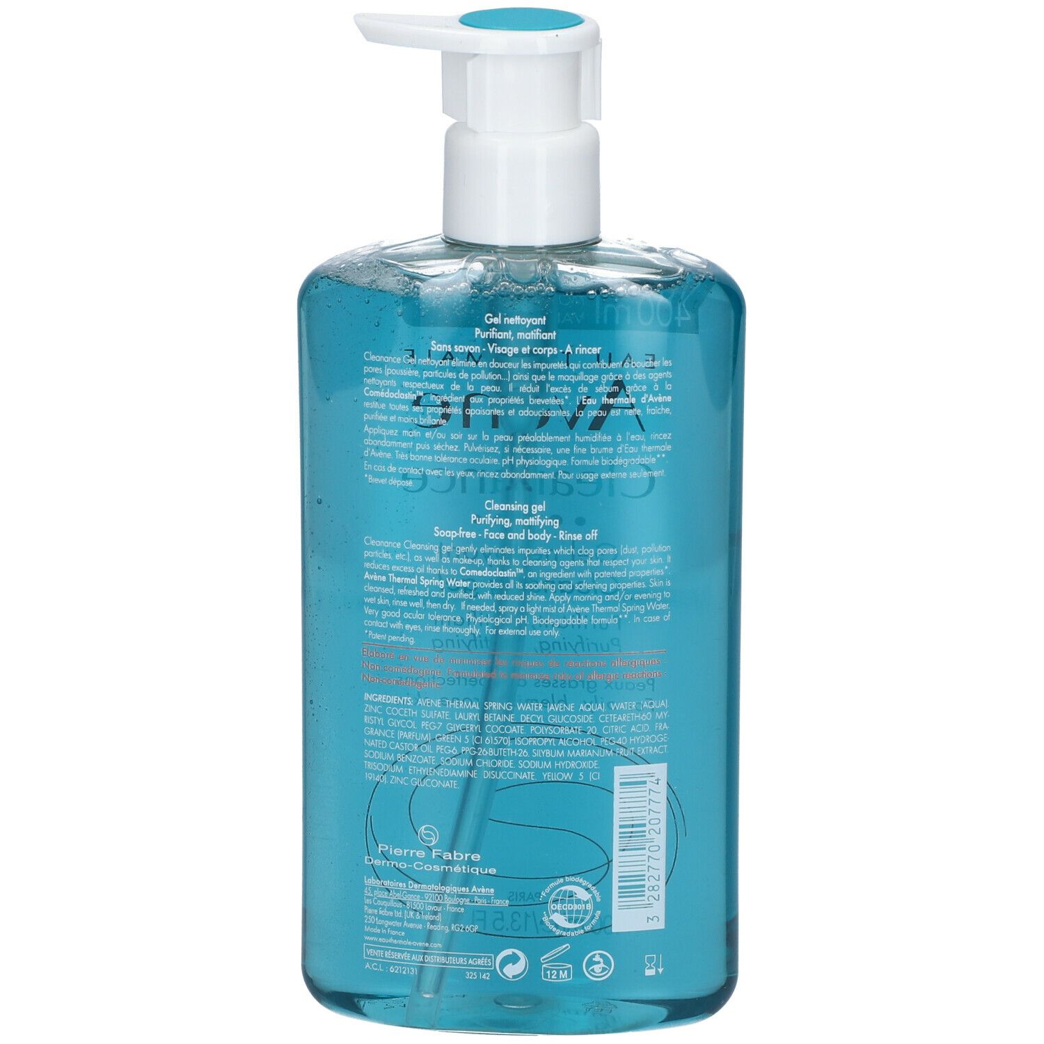 Dos d'un flacon turquoise avec pompe blanche. Texte en plusieurs langues.