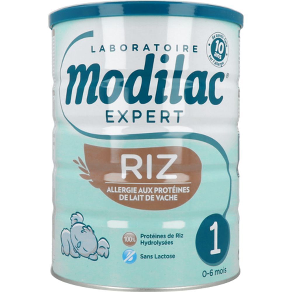 Modilac Expert 1 Riz melkpoederblik. Turkoois-wit ontwerp, blauw deksel. Opschrift: Riz, Allergie aux protéines de lait de vache.