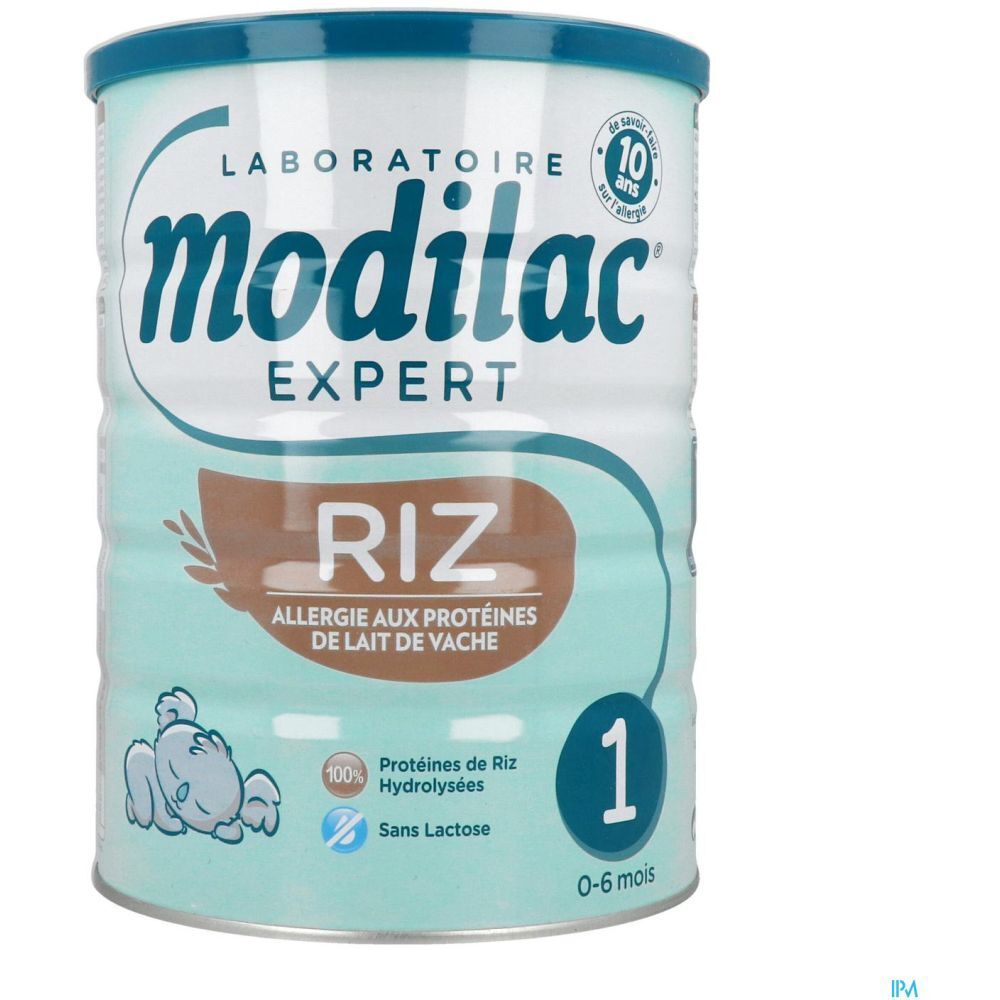 Modilac Expert 1 Riz melkpoederblik. Turkoois-wit ontwerp, blauw deksel. Opschrift: Riz, Allergie aux protéines de lait de vache.