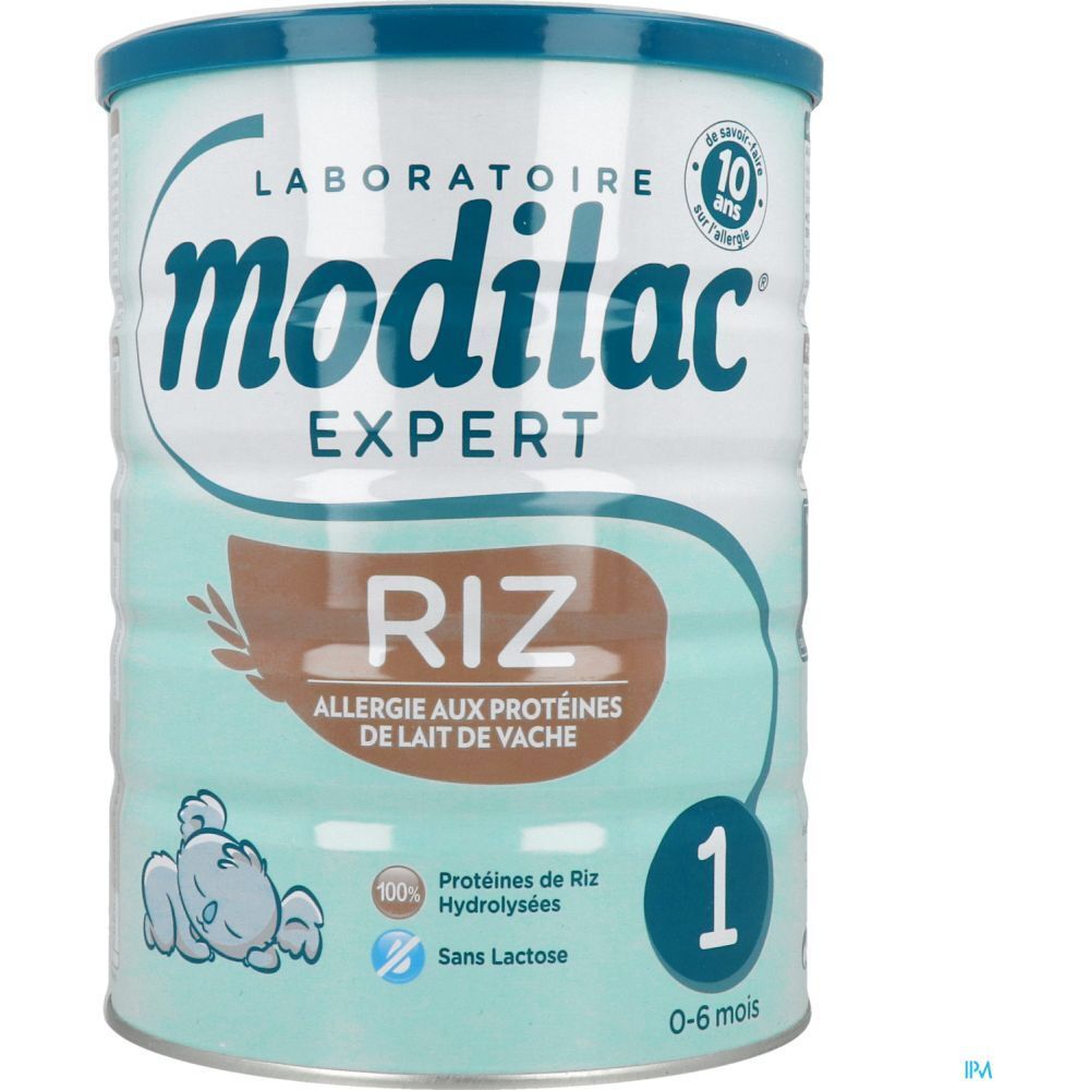 Modilac Expert 1 Riz melkpoederblik. Turkoois-wit ontwerp, blauw deksel. Opschrift: Riz, Allergie aux protéines de lait de vache.