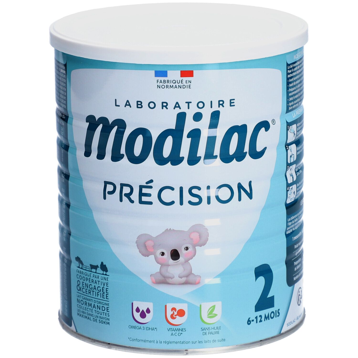 Lichtblauwe bus met witte deksel. Opschrift: Modilac Précision, 2, 6-12 maanden. Koala-illustratie.