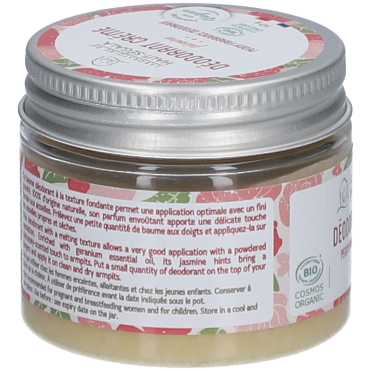 Achterkant van de crème deodorant pot. Tekst op etiket, bloemenpatroon. 'Cosmos Organic' certificering.
