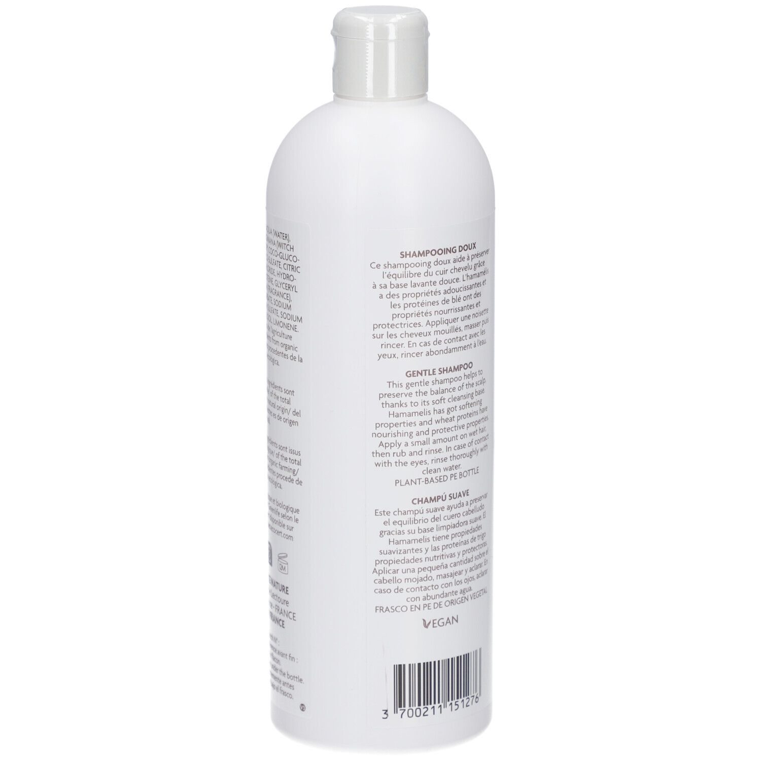 Achterkant van de witte shampoo fles. Tekst: DOUX, HAMAMELIS, tarweproteïnen. Vegan. Plant Based Bottle.