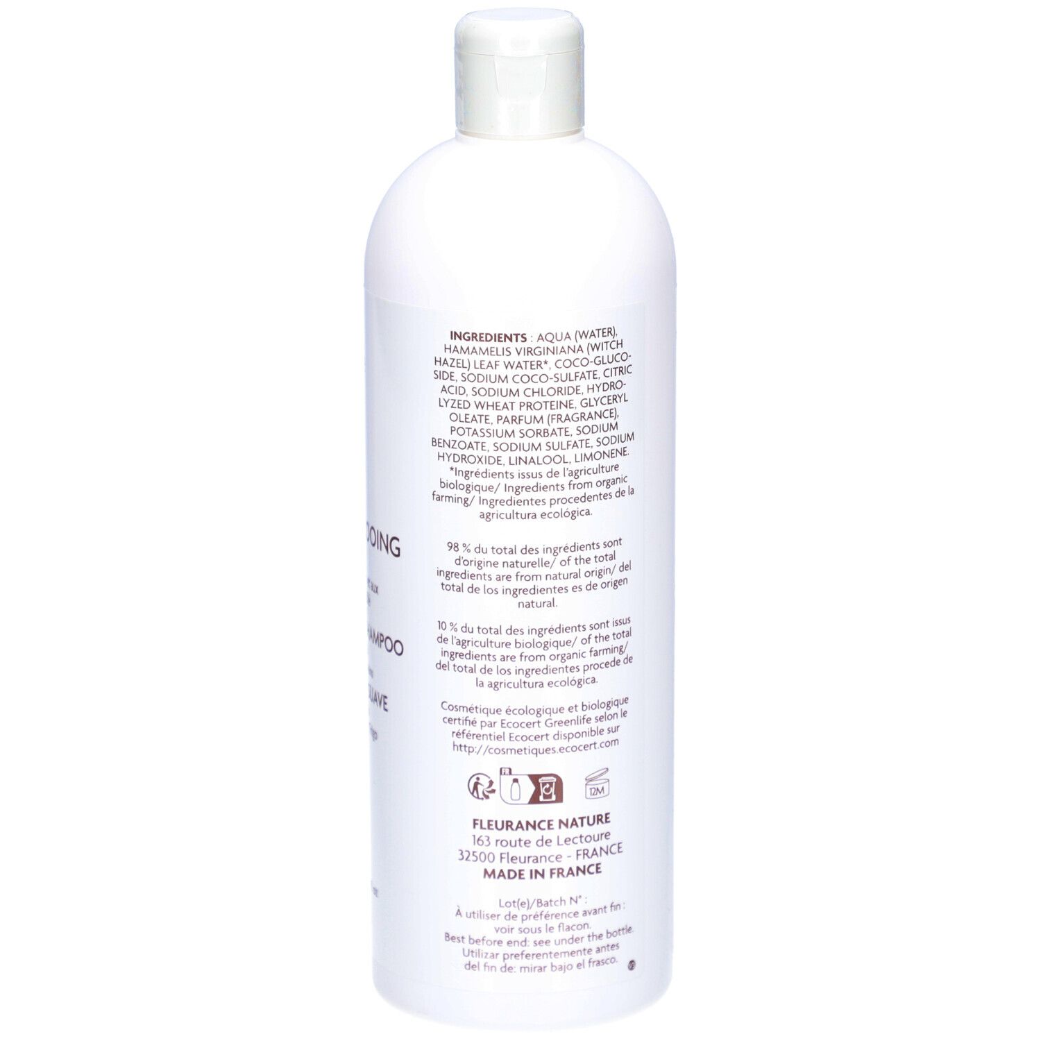 Achterkant van de witte shampoo fles. Tekst: Ingrediënten, DOUX, HAMAMELIS, tarweproteïnen. Gemaakt in Frankrijk.