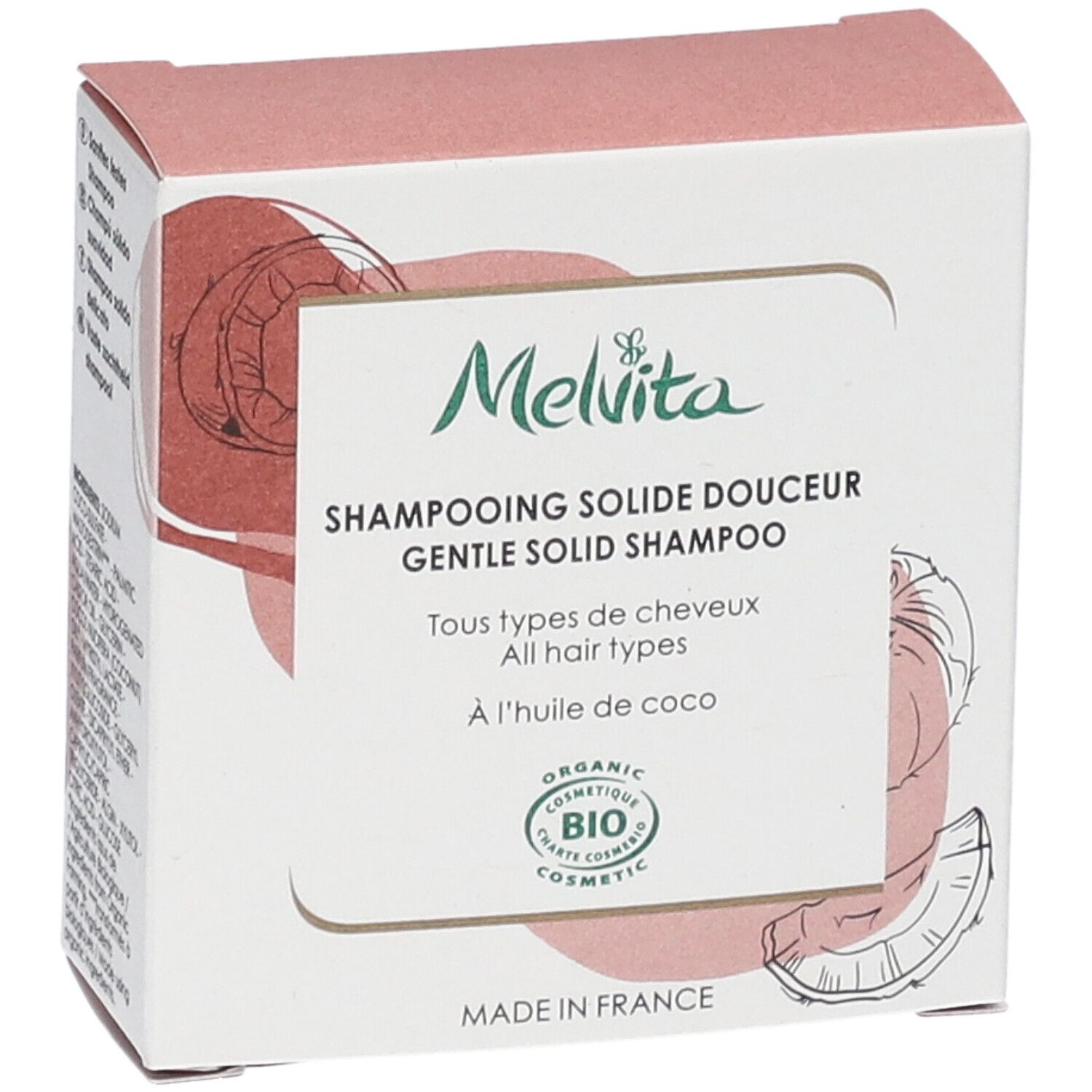 Zijaanzicht van de shampoo verpakking. Tekst: "Melvita", "Shampooing solide douceur", "BIO COSMETIC". Kokosnoot illustratie.