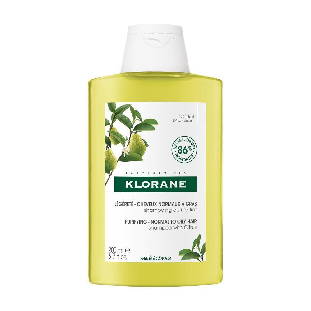 Shampoo jaune avec bouchon blanc. Inscription: KLORANE, 86% ingrédients naturels. Pour cheveux normaux à gras.