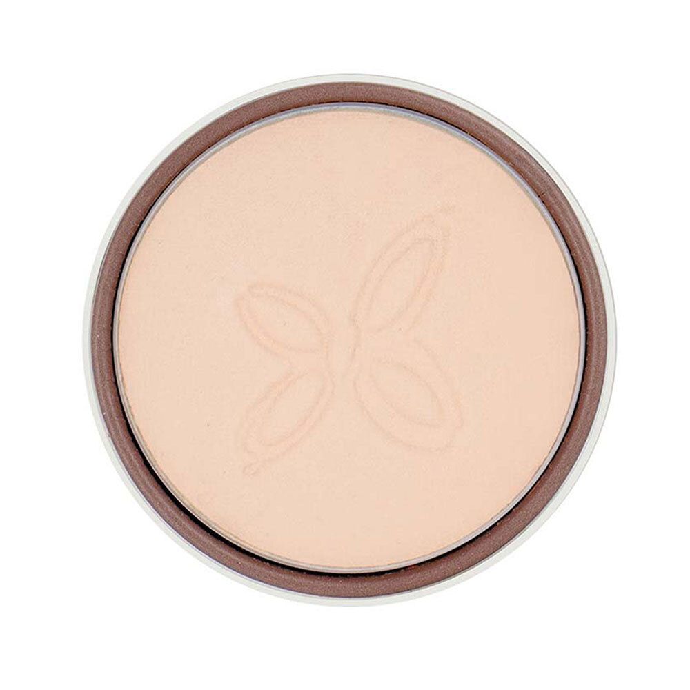 Fard à paupières beige dans un contenant marron. Motif blanc. Vue de dessus.