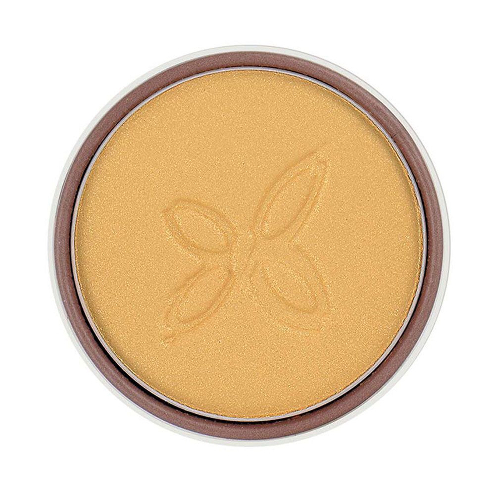 Gouden oogschaduw in ronde verpakking. Oppervlak met reliëf. Bruine rand.