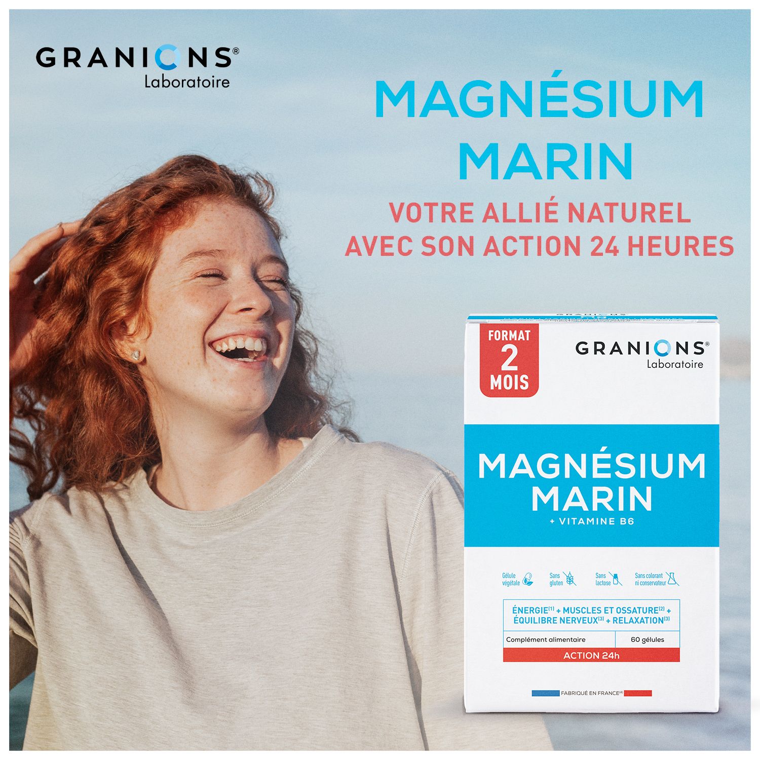 Lachende vrouw. Zee op de achtergrond. Rechts: Granions Magnesium Marin verpakking. 60 capsules.