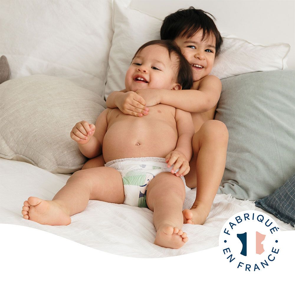 Twee baby's met luiers. Opschrift: Fabriqué en France. Luier met illustratie van een toekan.