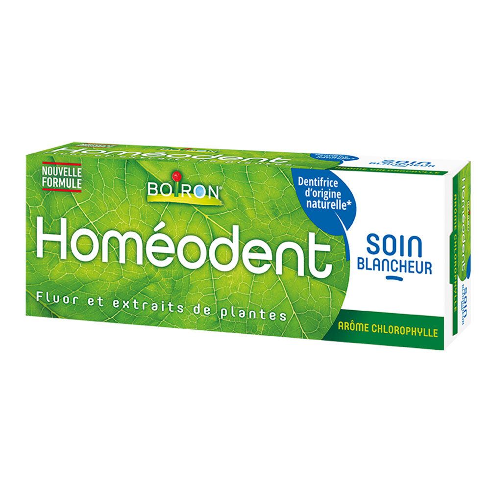 Groene en witte tandpastadoos. Opschrift: Homeodent, fluoride en plantenextracten. Merk Boiron.