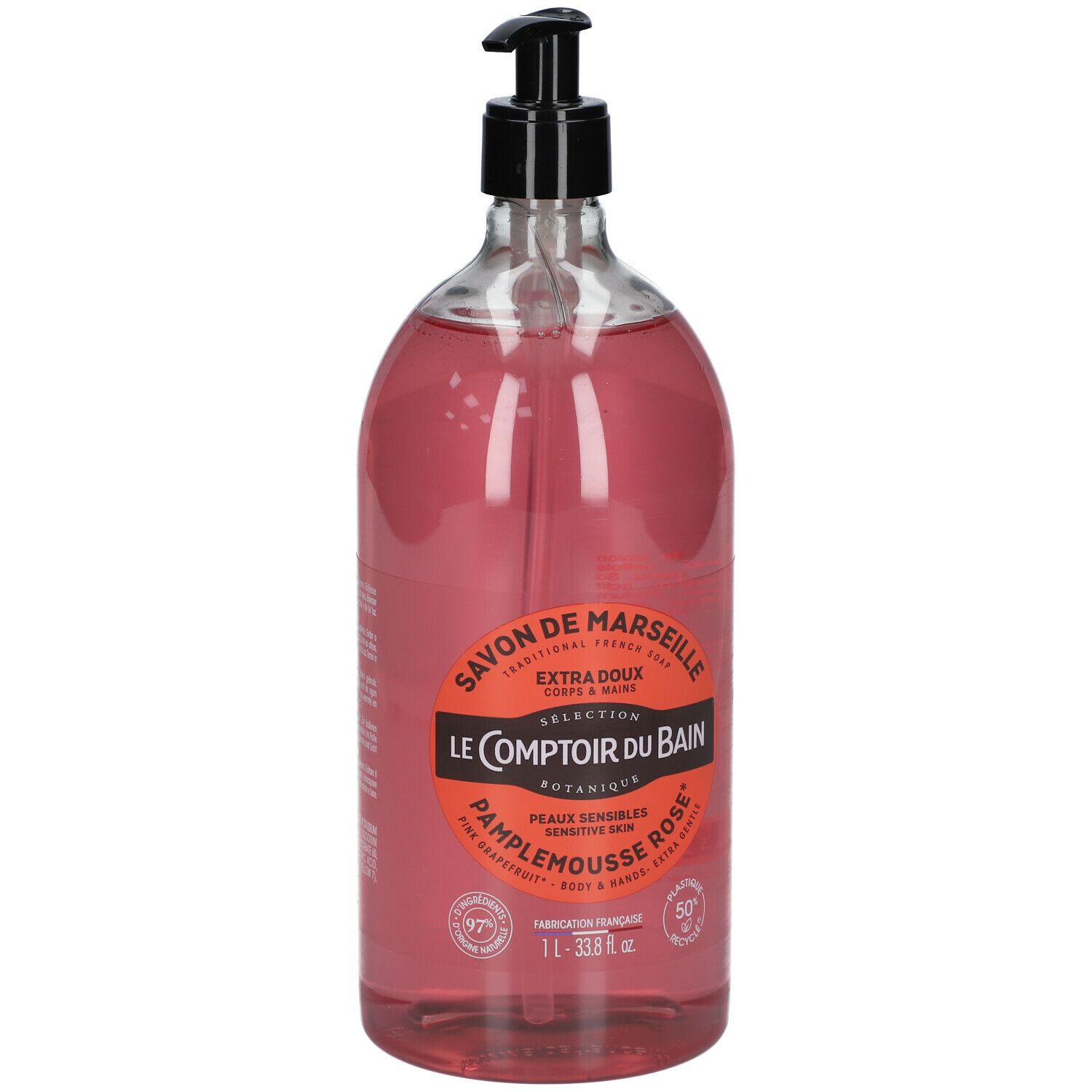 Transparante fles roze vloeibare zeep met zwarte pomp. Etiket met productinformatie.
