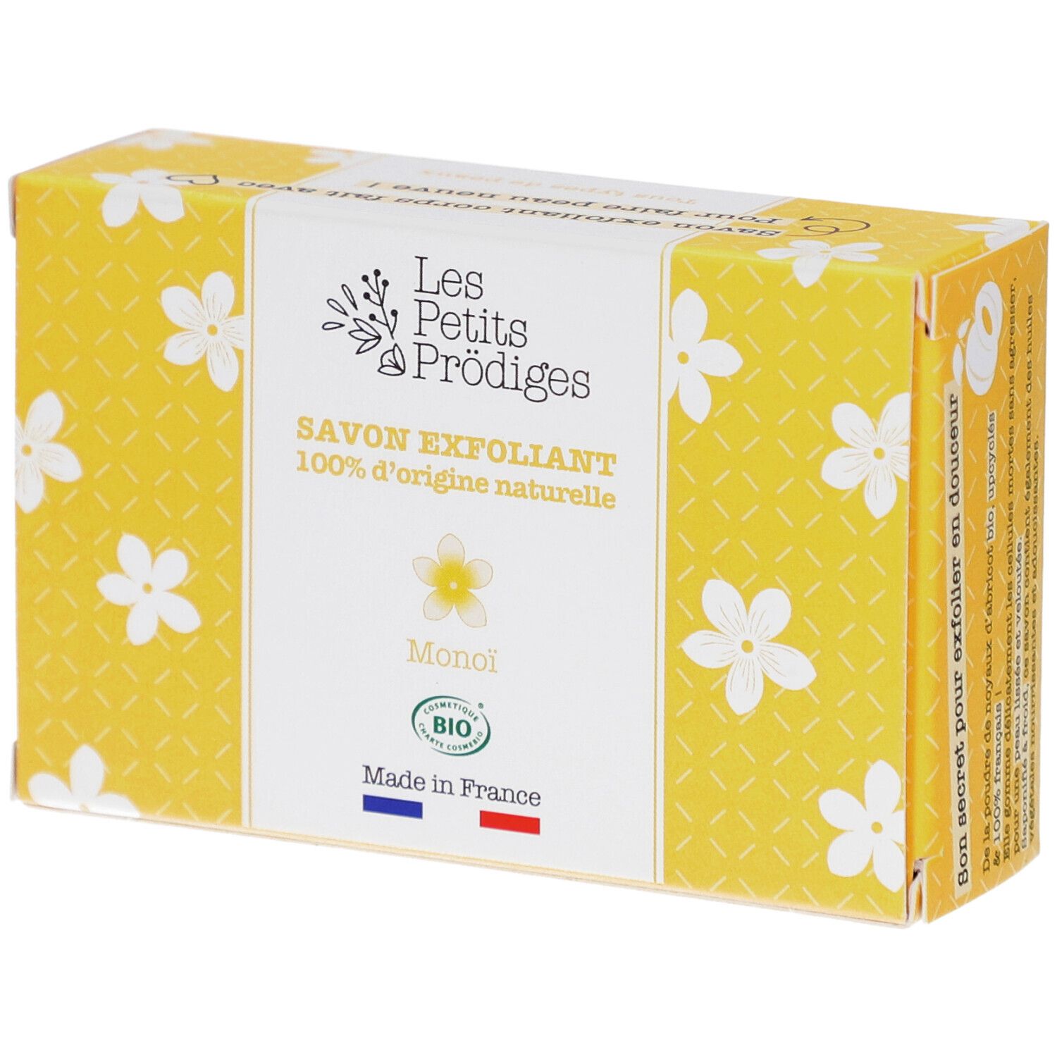 Gele doos met witte bloemmotieven. Opschrift: SAVON EXFOLIANT, 100% d'origine naturelle, Monoi, BIO. Franse vlag.