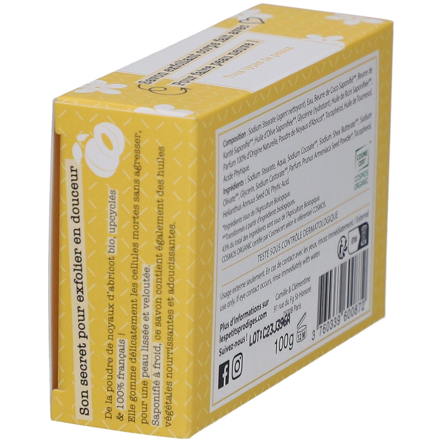 Gele doos met witte bloemmotieven. Opschrift: SAVON EXFOLIANT, 100% d'origine naturelle. Tekst over abrikozenpitolie.