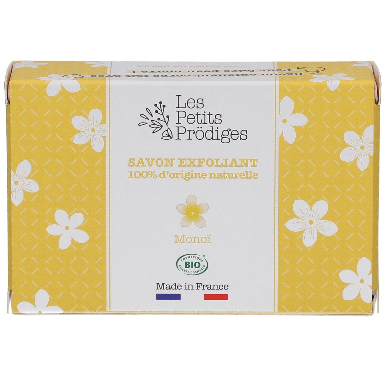 Gele doos met witte bloemmotieven. Opschrift: SAVON EXFOLIANT, 100% d'origine naturelle, Monoi, BIO. Franse vlag.