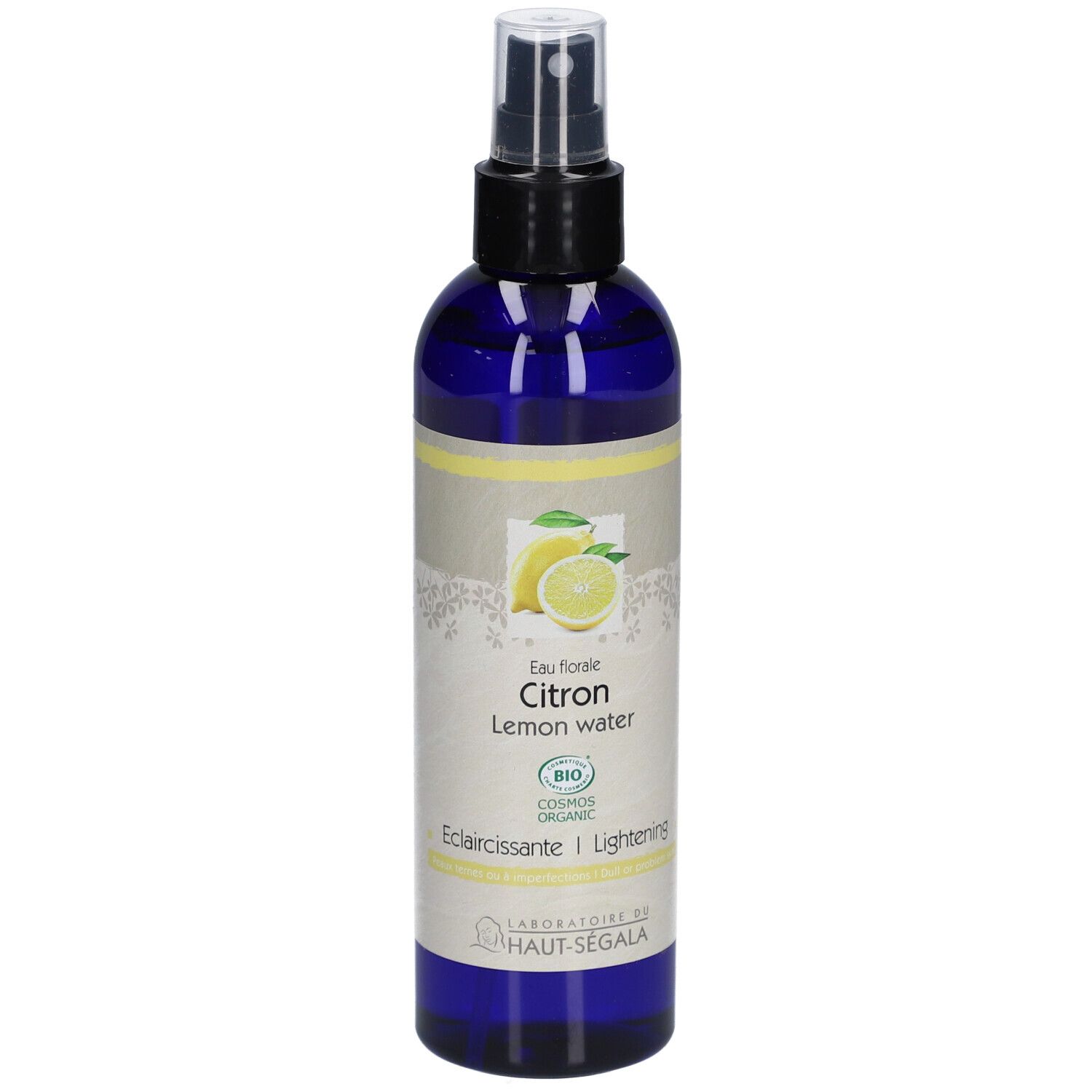 Flacon bleu avec vaporisateur. Étiquette avec citron, texte: Eau florale Citron, Lemon water, Eclaircissante/Lightening, Bio.