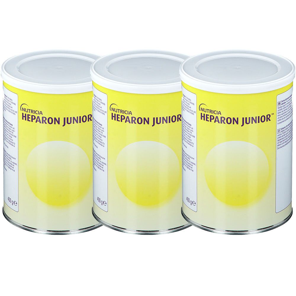 Trois boîtes de NUTRICIA HEPARON JUNIOR. Étiquettes jaunes, couvercles blancs. Inscription HEPARON JUNIOR et logo NUTRICIA.