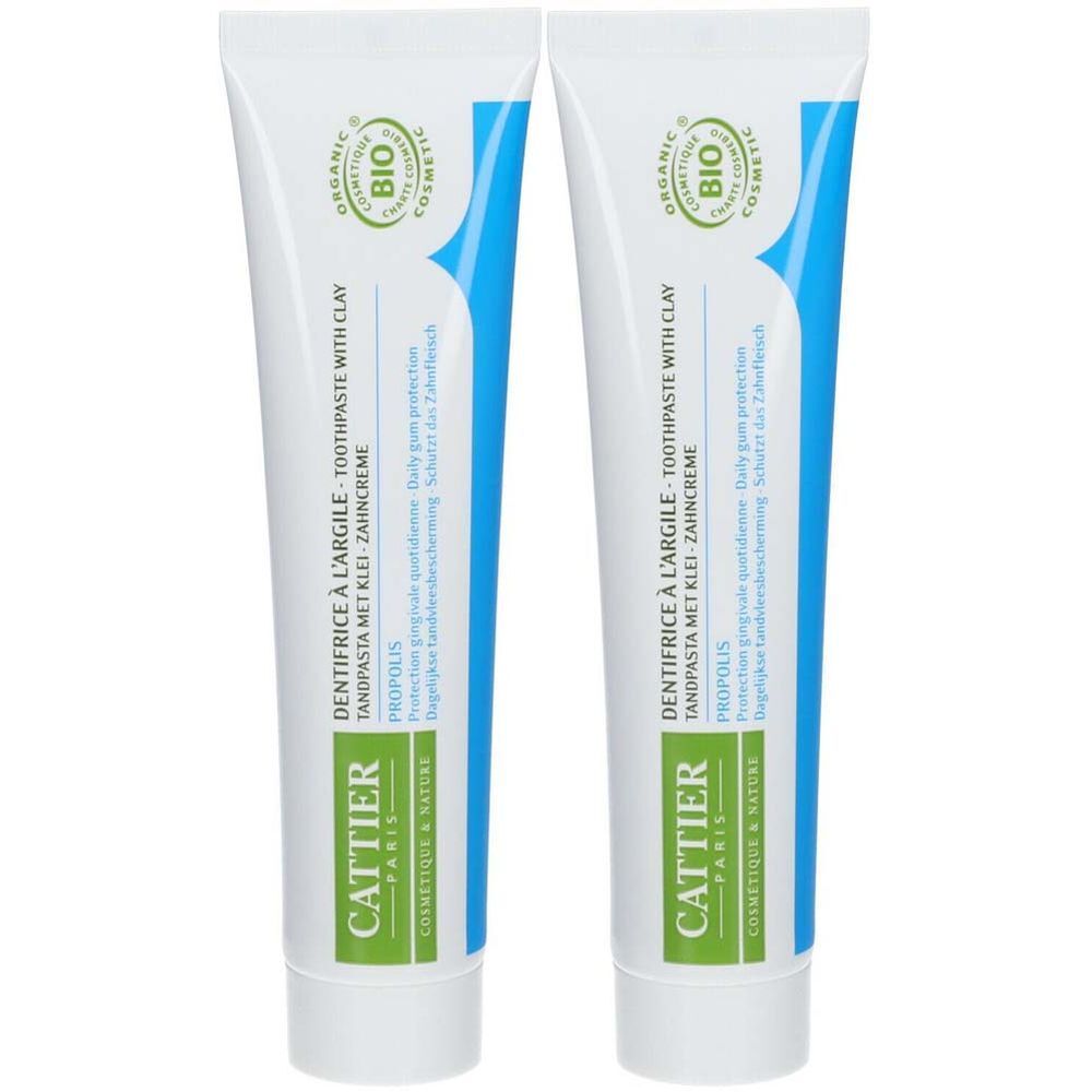 Deux tubes de dentifrice. Blancs, avec inscriptions bleues et vertes. Inscriptions: Cattier, DENTIFRICE À L'ARGILE, Propolis, BIO COSMETIC.