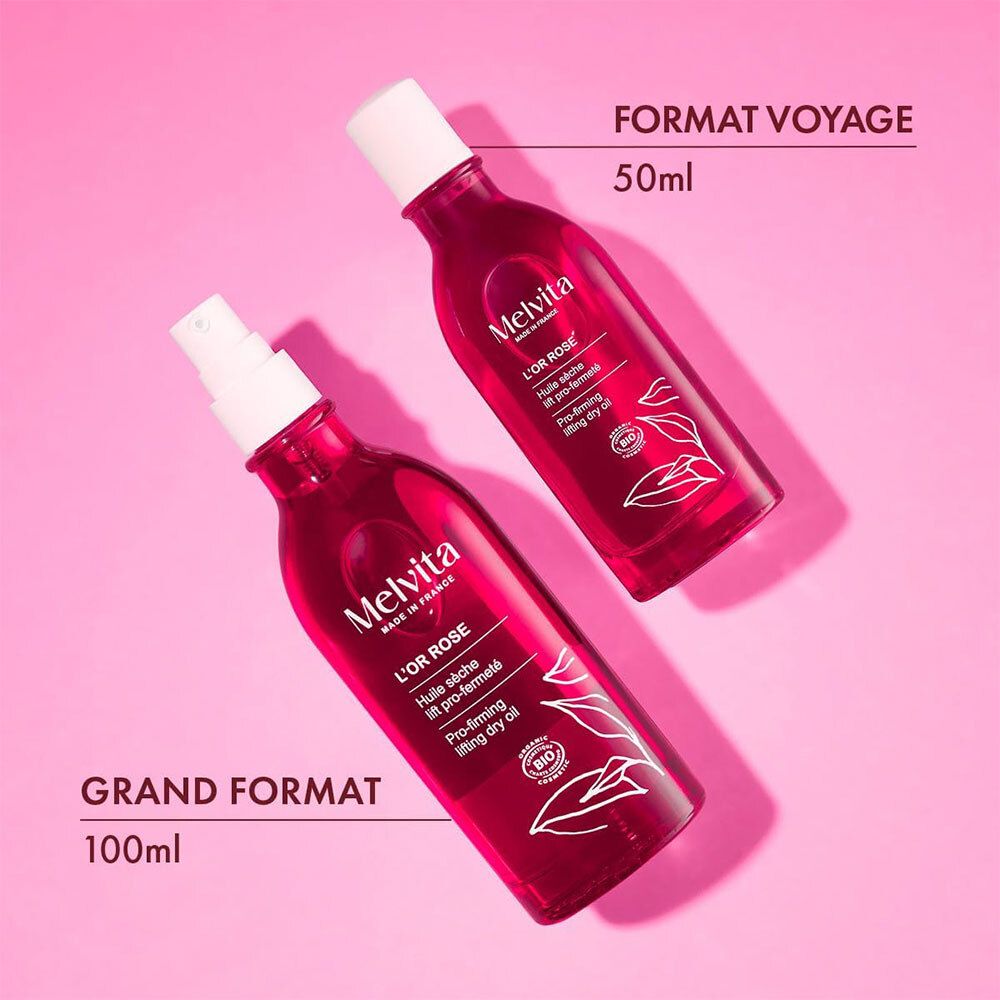 Deux flacons. Un de 50 ml, un de 100 ml. Texte: Format voyage 50 ml, Grand format 100 ml. Melvita L'Or Rose.