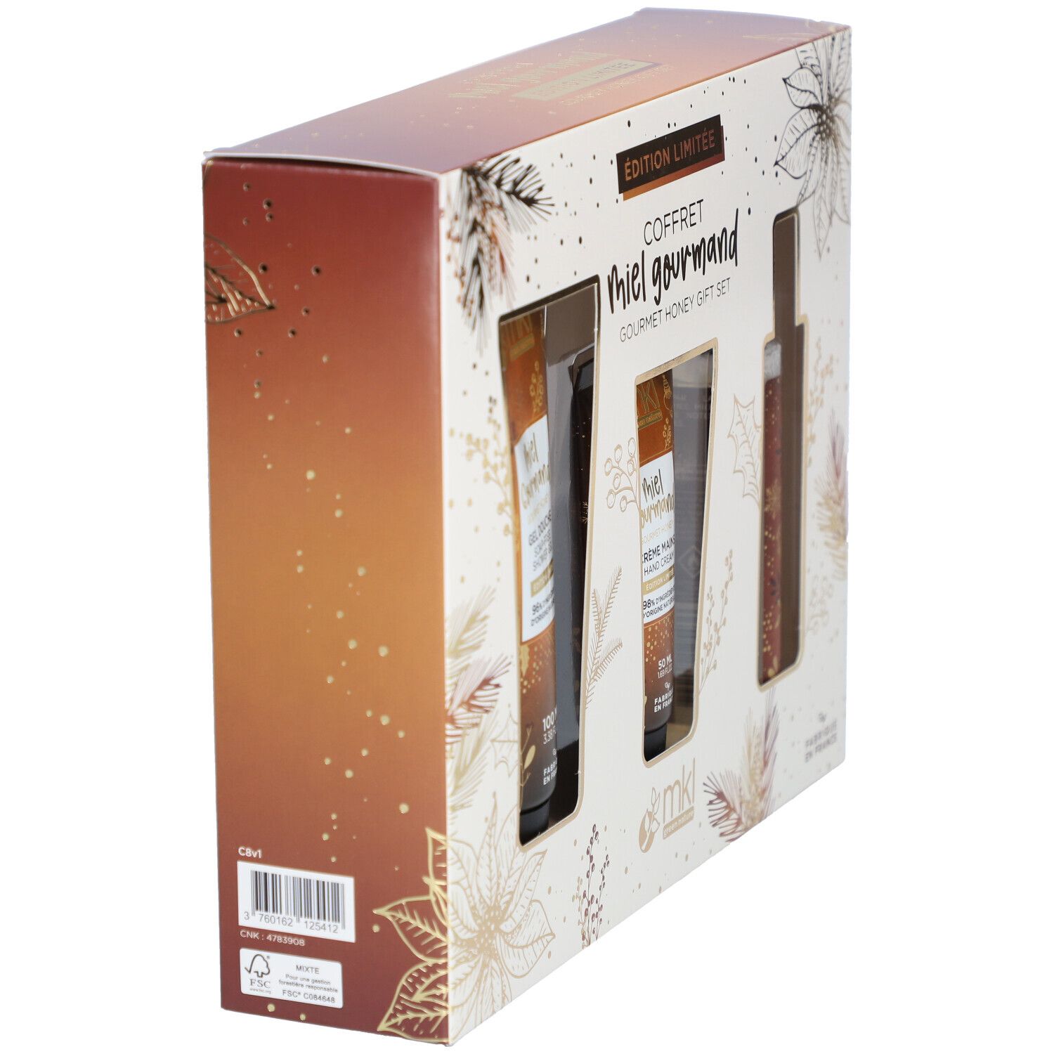 Vue latérale d'un coffret cadeau. Motifs floraux et nom du produit "Miel Gourmand" visibles. Angle de vue oblique.