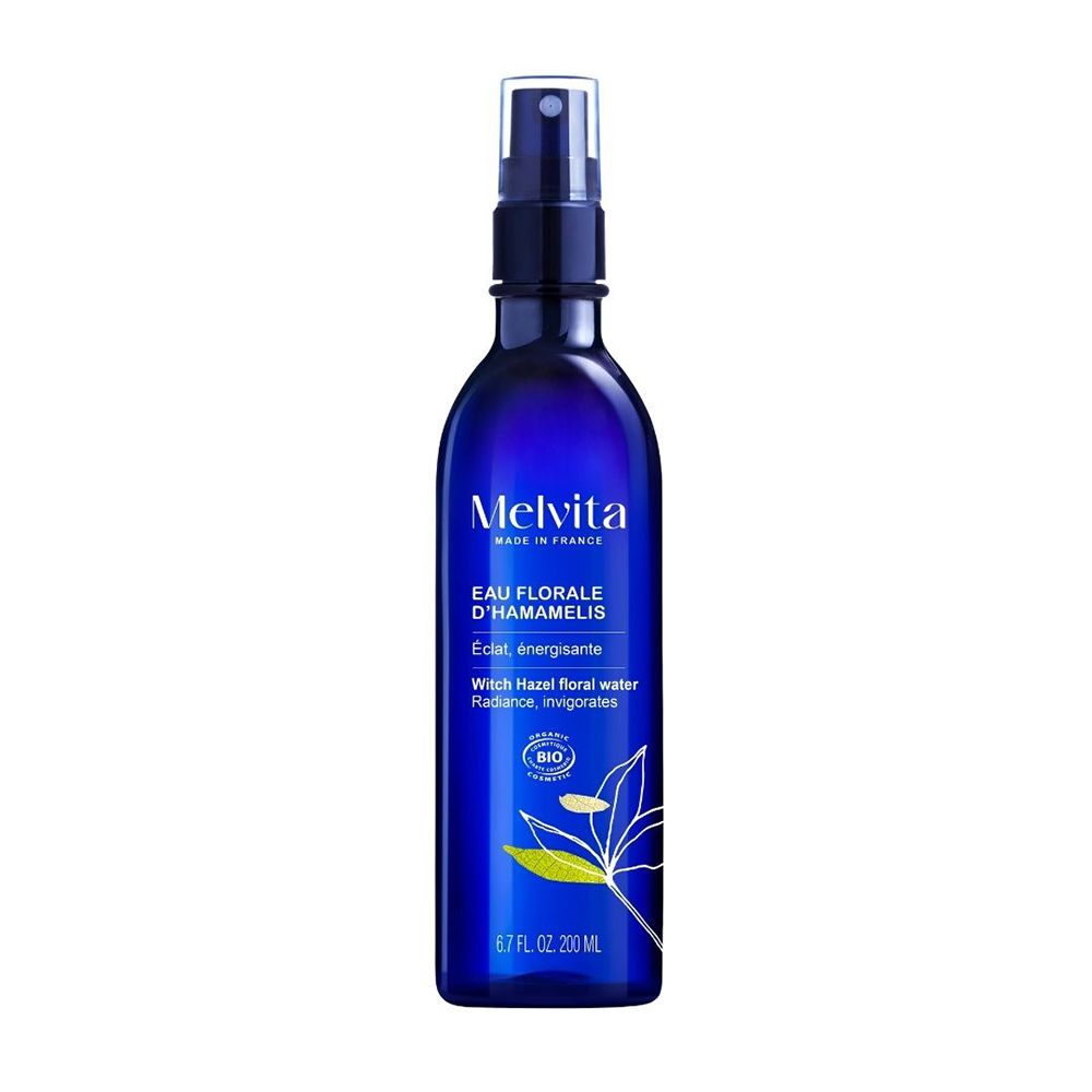Eau florale Melvita Hamamélis dans un flacon spray bleu.