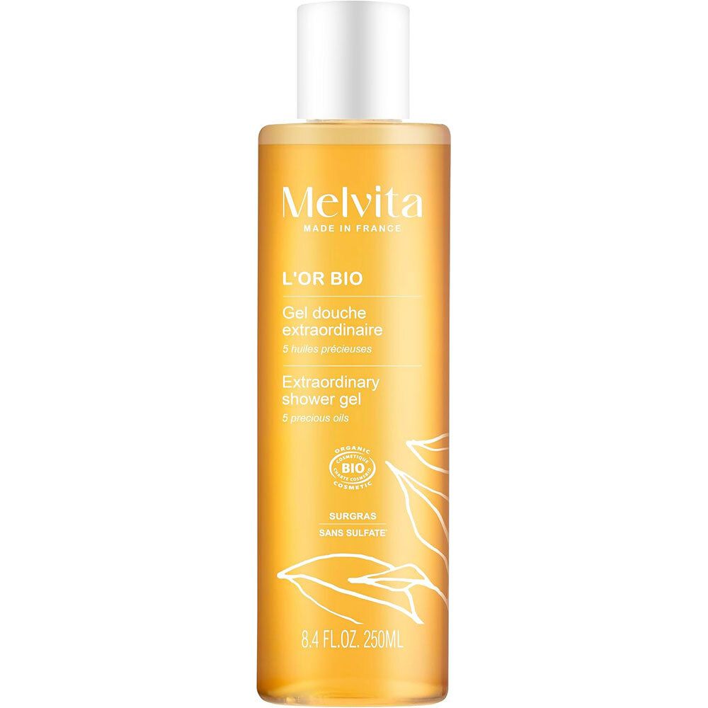 Melvita L'Or Bio Gel Douche Extraordinaire. Transparante fles, gouden vloeistof, witte dop. Logo, bio-certificering, 250ml.