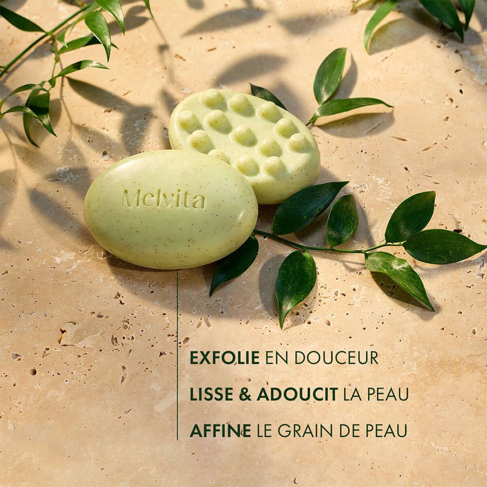 Deux savons, un avec billes, un ovale, vert clair. Texte : MELVITA.