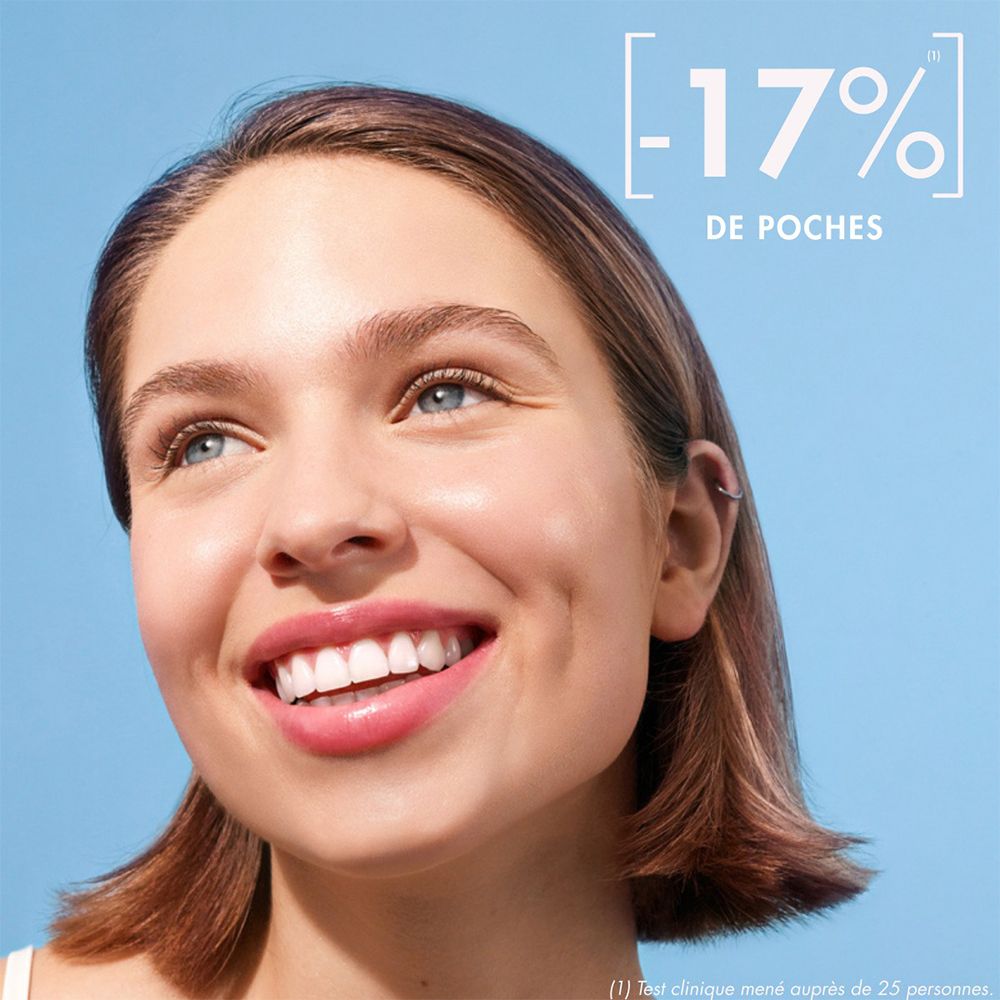 Jonge vrouw met een stralende glimlach. Tekst: -17% wallen.