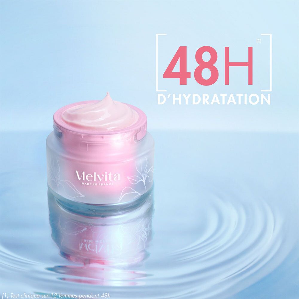 Product met roze crème in water. Tekst: 48H D'HYDRATATION. Melvita-logo. Roze crème op deksel.