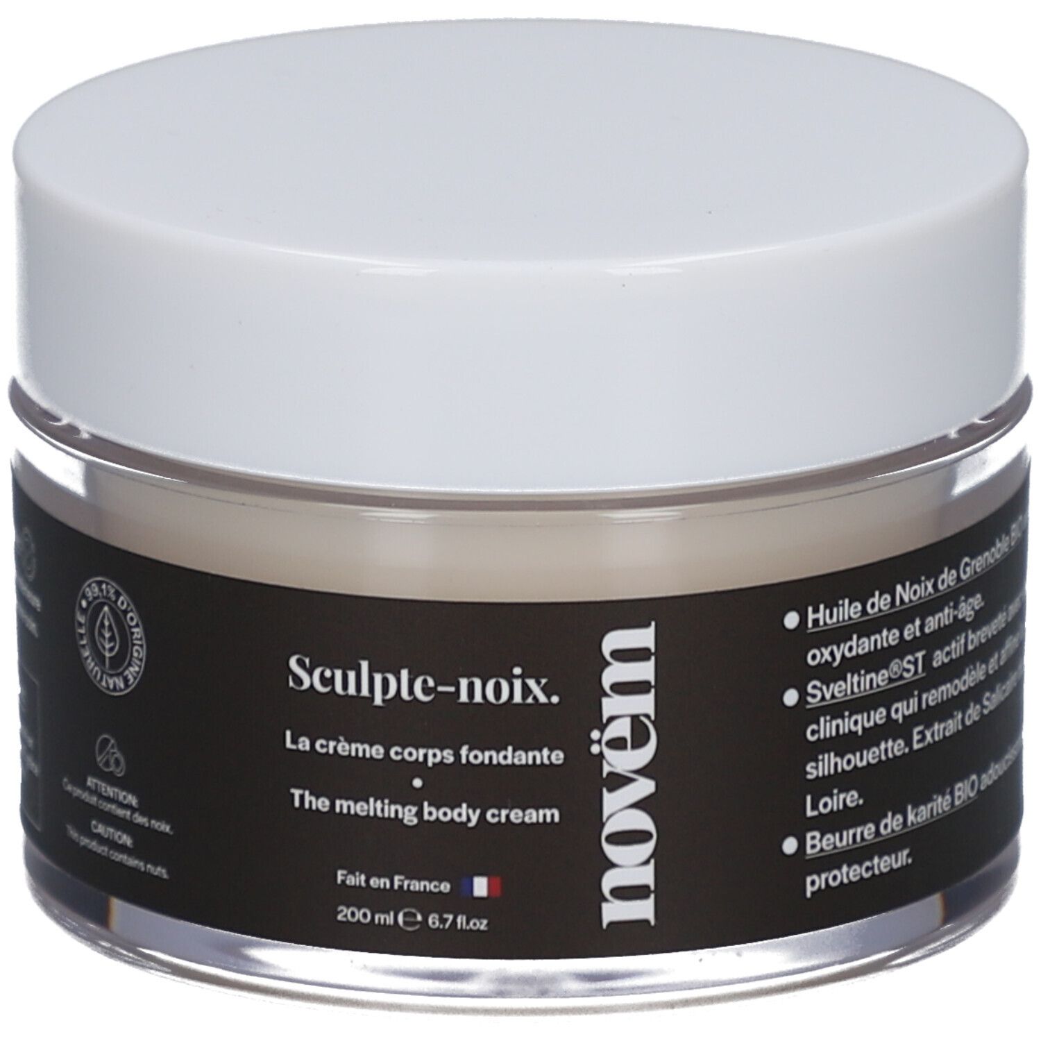 Crèmepot met witte deksel. Zwart etiket met tekst: Sculpt-noix, La crème corps fondante, novëm. 200 ml. Transparant glas.