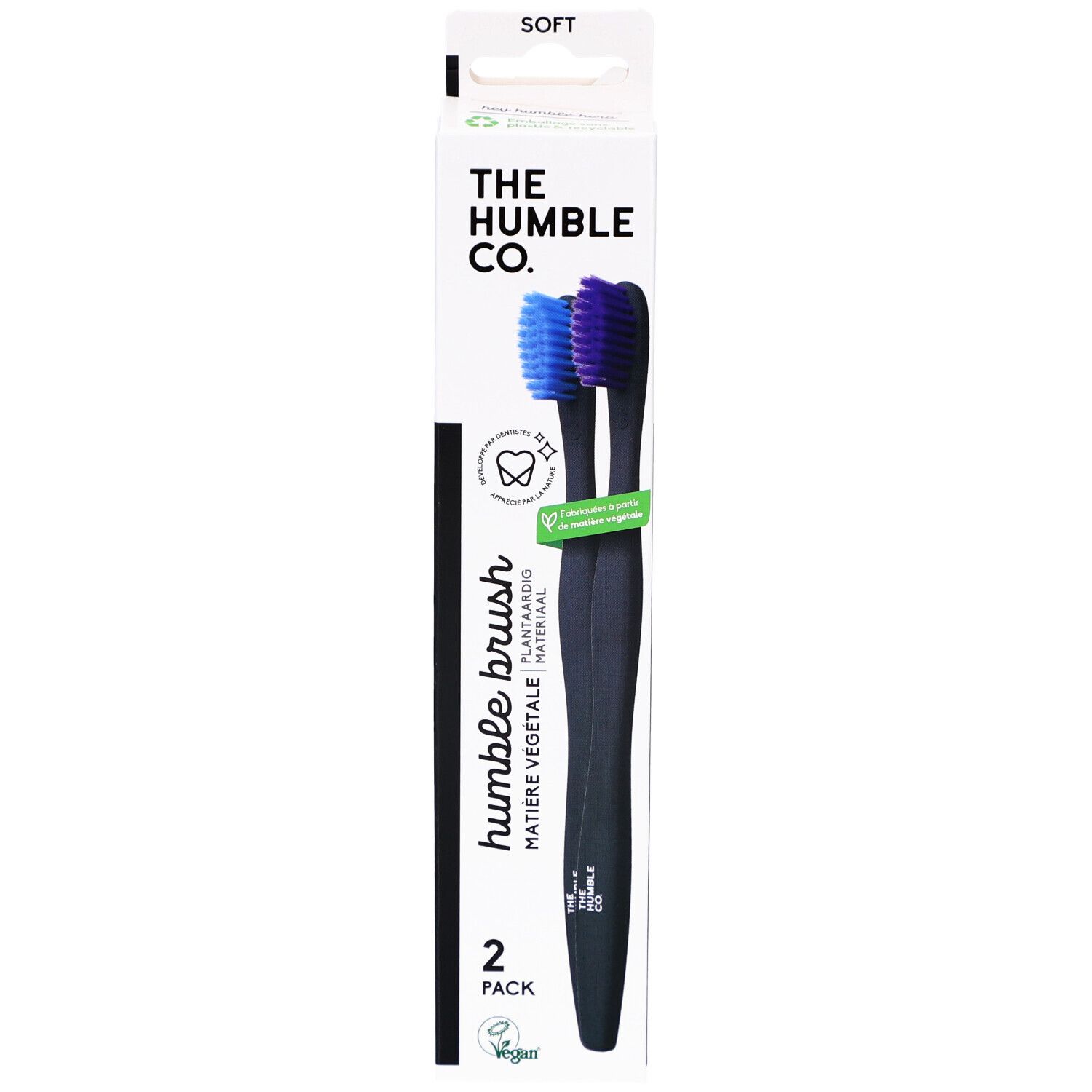 Verpakking met twee zwarte tandenborstels. Blauwe en paarse borstelharen. Opschrift: Humble Brush, 2-pack.