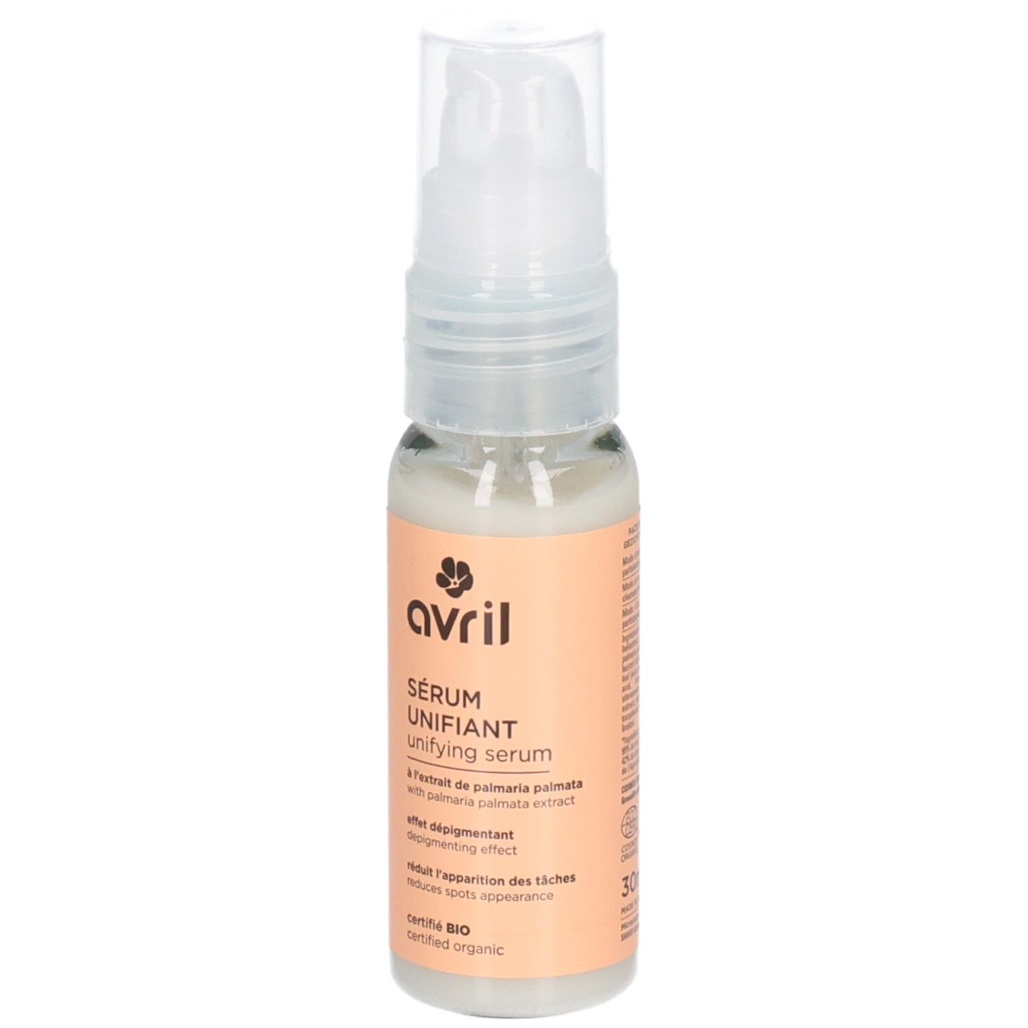 Transparante fles met pomp. Etiket met productnaam, merk en certificering. Bevat serum. Biologische certificering.