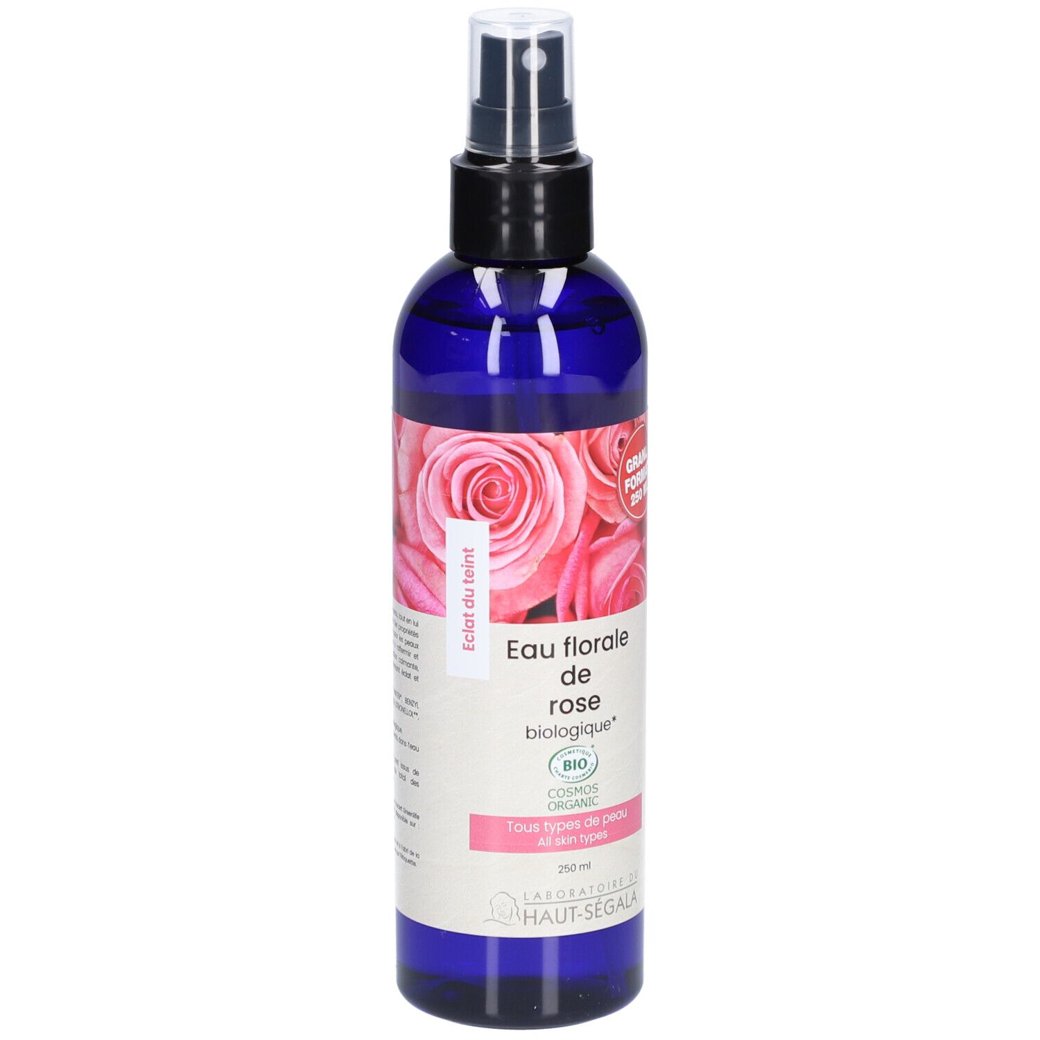 Blauwe fles met verstuiver. Etiket met rozenmotief en tekst: Eau florale de rose biologique. Bio-certificering. Groot formaat.