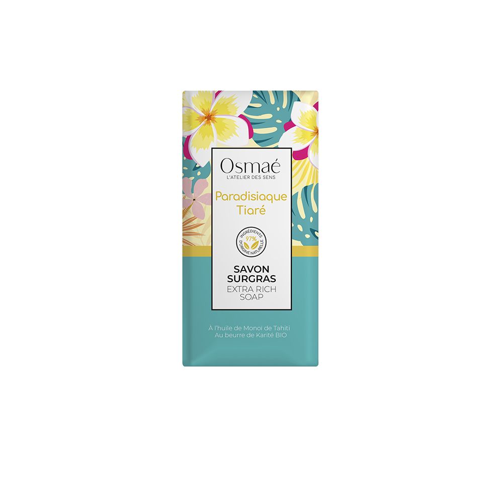 Rechthoekige zeep in verpakking. Merk OSMAE, productnaam Paradisiaque Tiaré. Opschrift Savon Surgras Extra Rich Soap. Bloemenpatroon.