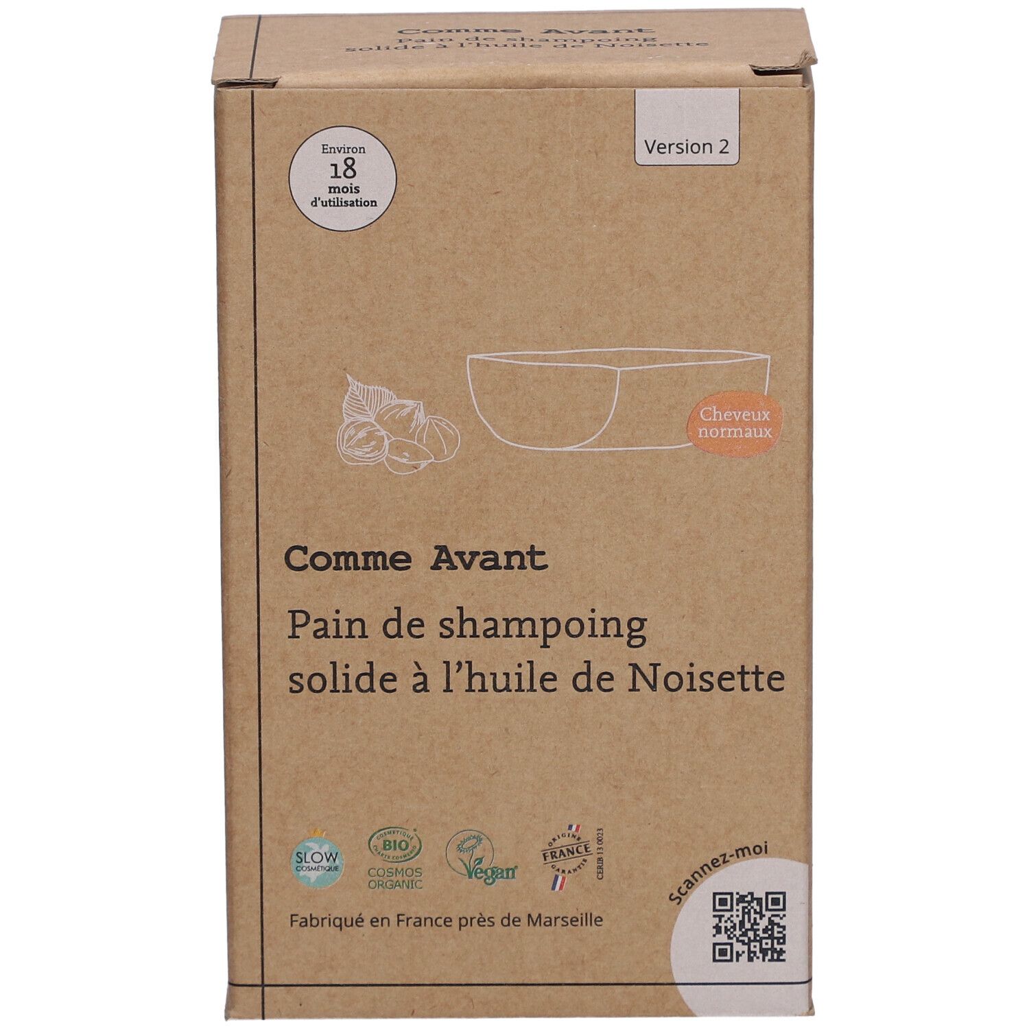 Kartonnen verpakking met productinformatie. Opschrift: Comme Avant, Pain de shampoing solide à l'huile de Noisette. Met illustratie.